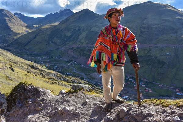 Indio mountain guide with hat and poncho in the Andes