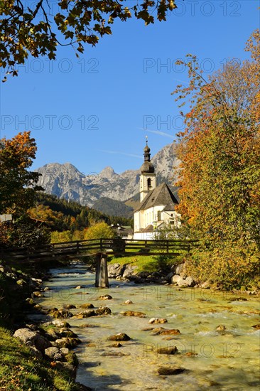 Parish church St. Sebastian in autumn with Ramsauer Ache