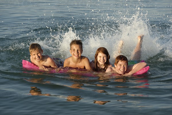 Children on a lilo in the sea