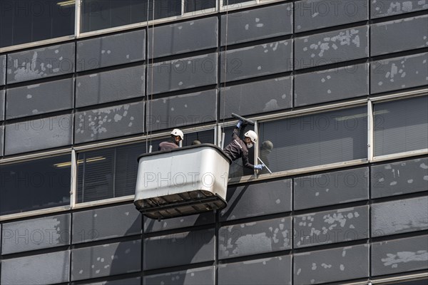 Two window cleaners at a skyscraper