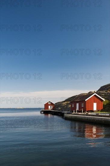 Red wooden hut by the sea