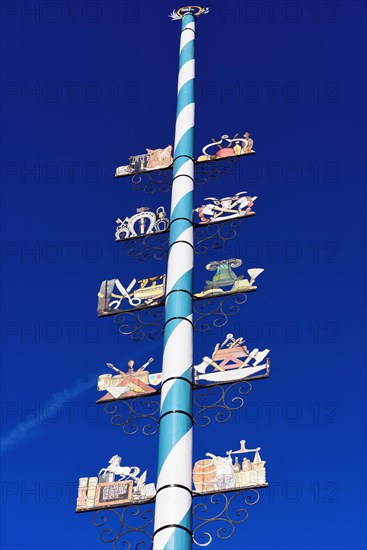 Maypole with wooden signs of local trades