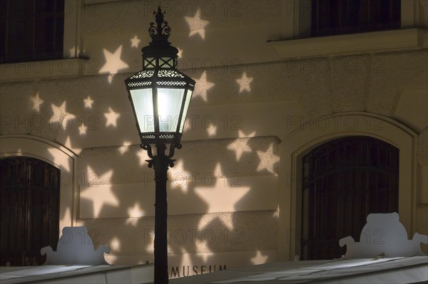 Street lamp with Christmas lights and Hofburg Palace