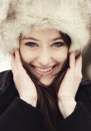 Smiling young woman wearing a fur hat