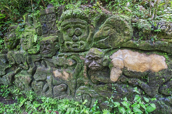 Moss-covered sculpture in the forest