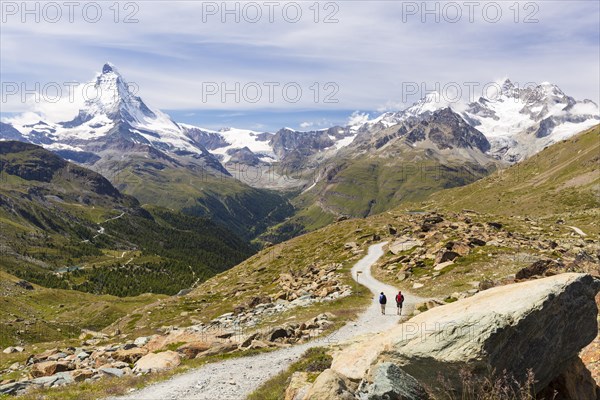 Two hikers on a trail to Stellisee lake