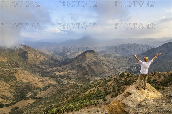 Woman enjoying the view over the mountains along the road from Massawa to Asmarra