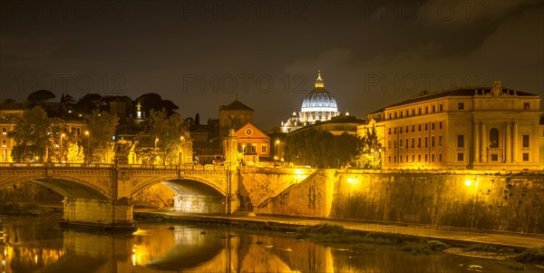View from Ponte Sant'Angelo across the Tiber River to St. Peter's Basilica at night