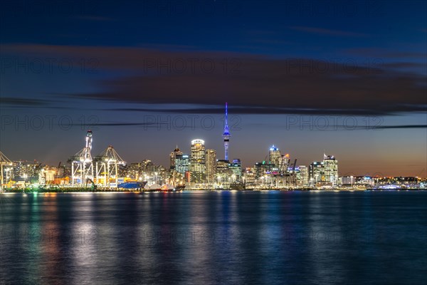 Illuminated skyline of Auckland at sunset
