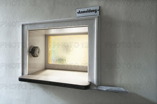 Former front desk with window and bell at an industrial plant