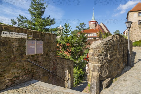 Muhltorgasse street at Fischerpforte gate with the old water tower and St. Michael's Church