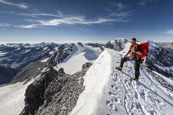 Mountaineer on the summit ridge of the Tuckettspitze on Stelvio Pass