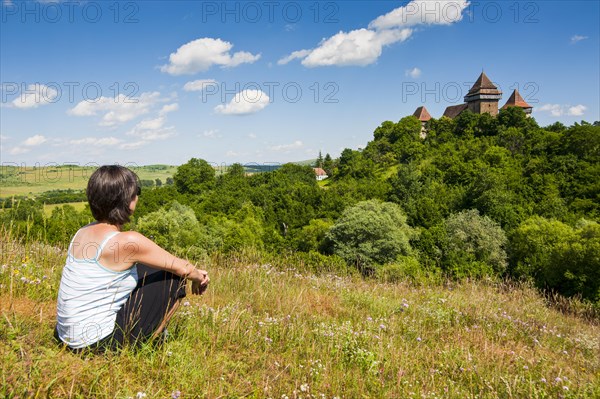 Woman looking at the fortified Saxonian church