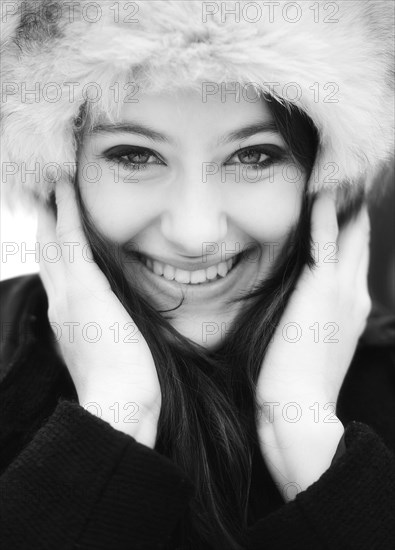 Smiling young woman wearing a fur hat