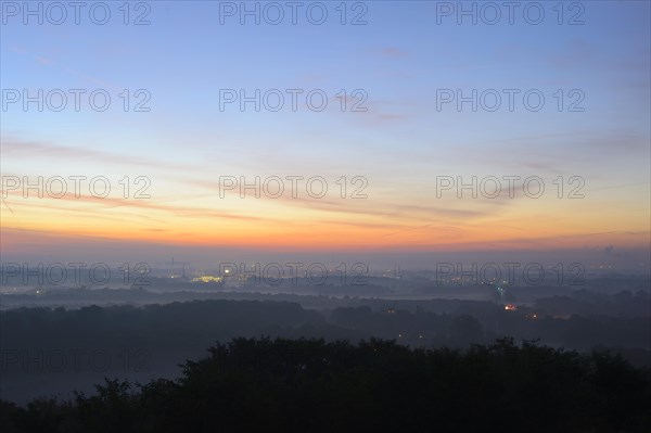 View from the Halde Norddeutschland spoil tip onto the Lower Rhine and the western Ruhr district at dawn