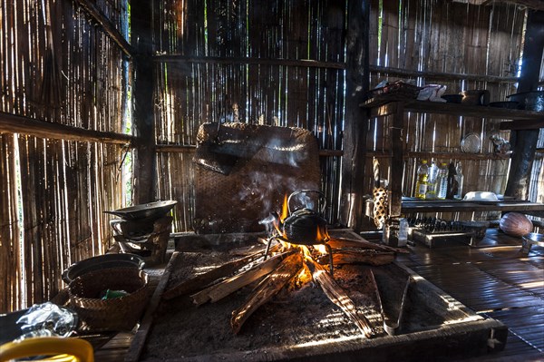 Kettle over an open fire in a kitchen made of bamboo