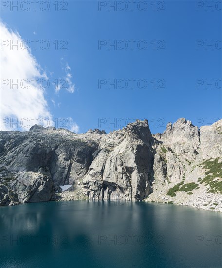 Mountain lake Lac de Melo surrounded by cliffs