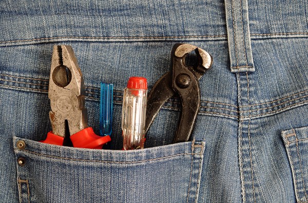 Pliers and screwdrivers in a back pocket