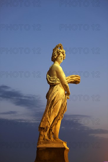 Seasons statue on Ponte Santa Trinita bridge spanning the river Arno