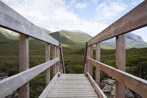 Wooden bridge over Allt Dearg Mor with a view towards Glen Sligachan