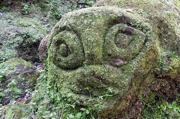 Moss-covered sculpture in the forest
