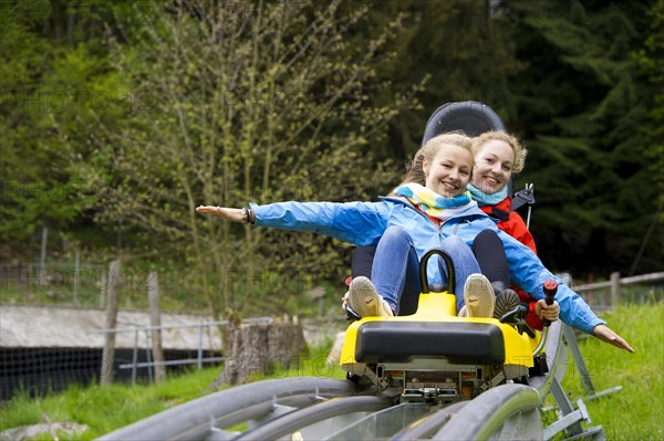 Young women on a summer toboggan run