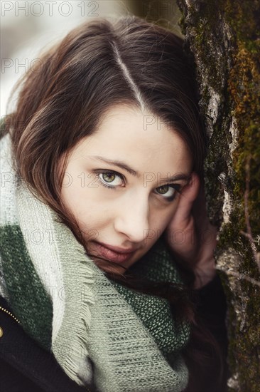 Thoughtful young woman wearing a scarf