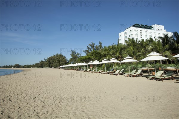 Beach with sun beds of the Saigon Ninh Chu Resort on the beach of Phan Rang
