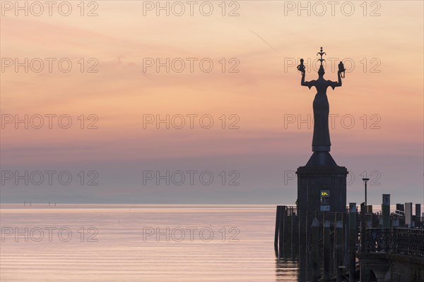 Statue of Imperia at the entrance of the harbour of Konstanz at dawn