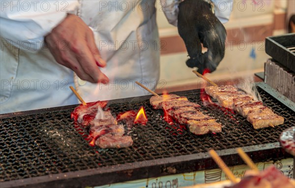 Grilled meat skewers at a food stand