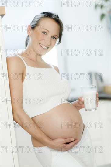 Pregnant woman holding a glass of milk