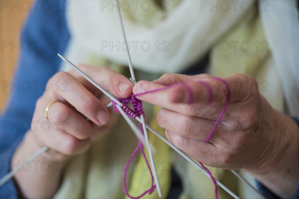 Hands of a senior knitting