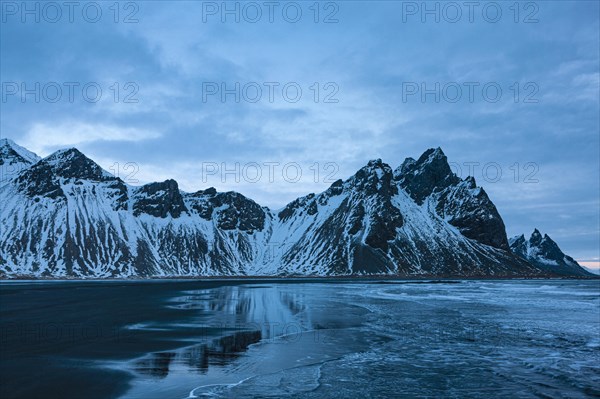 Mount Vestrahorn with black lava rim at dawn