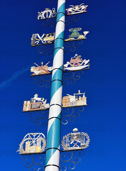 Maypole with wooden signs of local trades