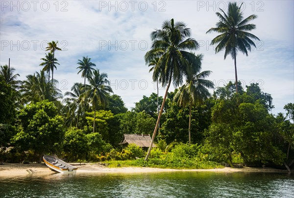 Thatched roof hut on a channel between twin island off the coast of Kavieng