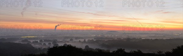 View from the Halde Norddeutschland spoil tip onto the Lower Rhine and the western Ruhr district at dawn