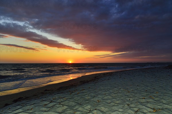 Sunset at sea with cloudy sky