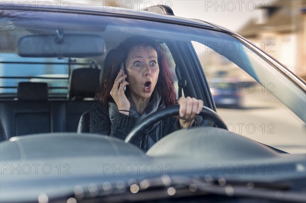 Motorist without a seat belt making a call on a mobile phone