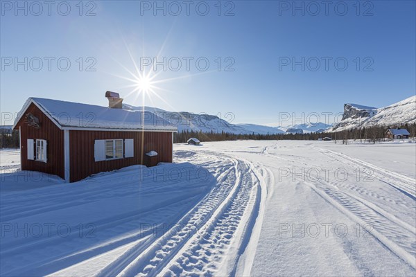 Wooden huts STF Aktse Fjallstuga in winter