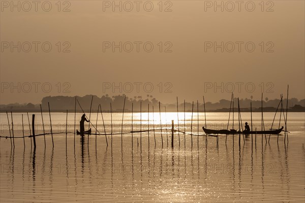 Fishermen in boats in the evening light