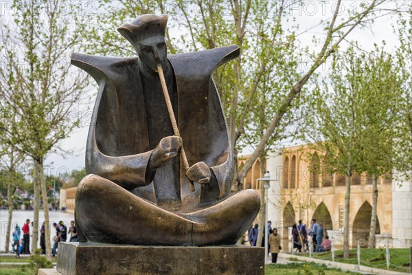 Musician sculpture on the Zayande-Rud riverbank at Si-o-se Pol Bridge or Allah-Verdi Khan Bridge