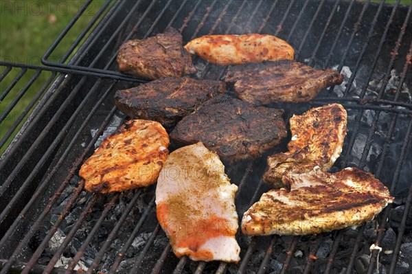 Heavily roasted meat on a charcoal grill