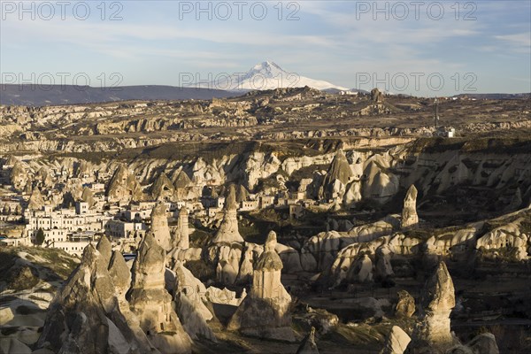 The village of Goreme in front of the snow-capped volcano Erciyes Dagi