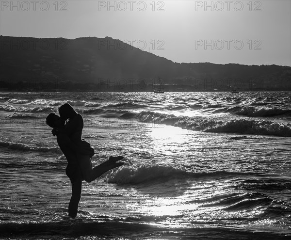 Young couple on the beach kissing