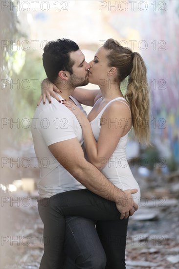 Young couple kissing in a ruined building