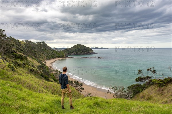 Young man looking over a bay