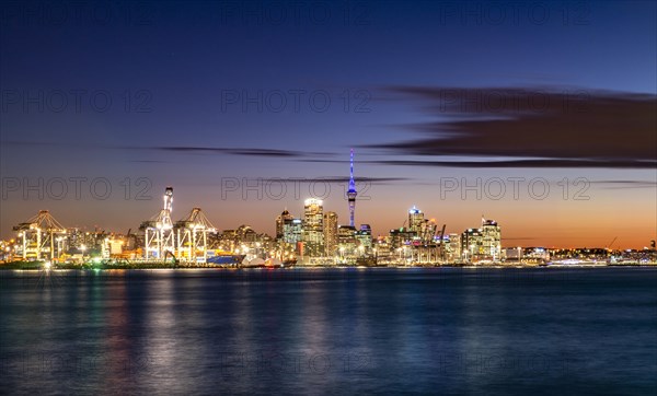 Illuminated skyline of Auckland at sunset