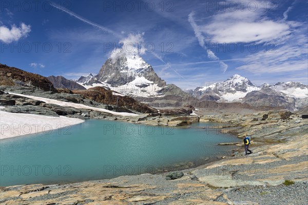 Hiker at glacier lake on the way to the Gandegg hut