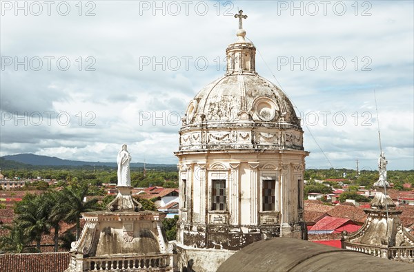 Dome of the church Iglesia de la Merced above the red roofs of Granada