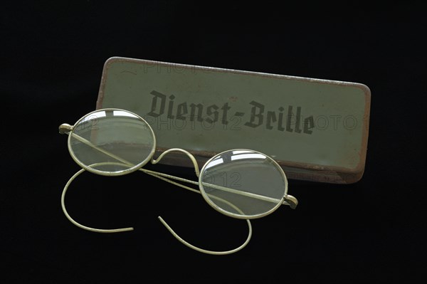 Service glasses from 1938 with a sheet metal case on black